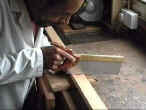 Carpenter Sawing a Plank of Wood